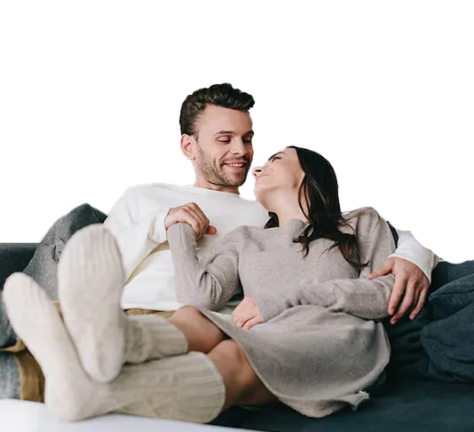 Warm comfortable couple on couch | Heating & Furnace Repair Hero | Emerald Coast Air Conditioning & Heating | AirConditiongRepairPensacola.com